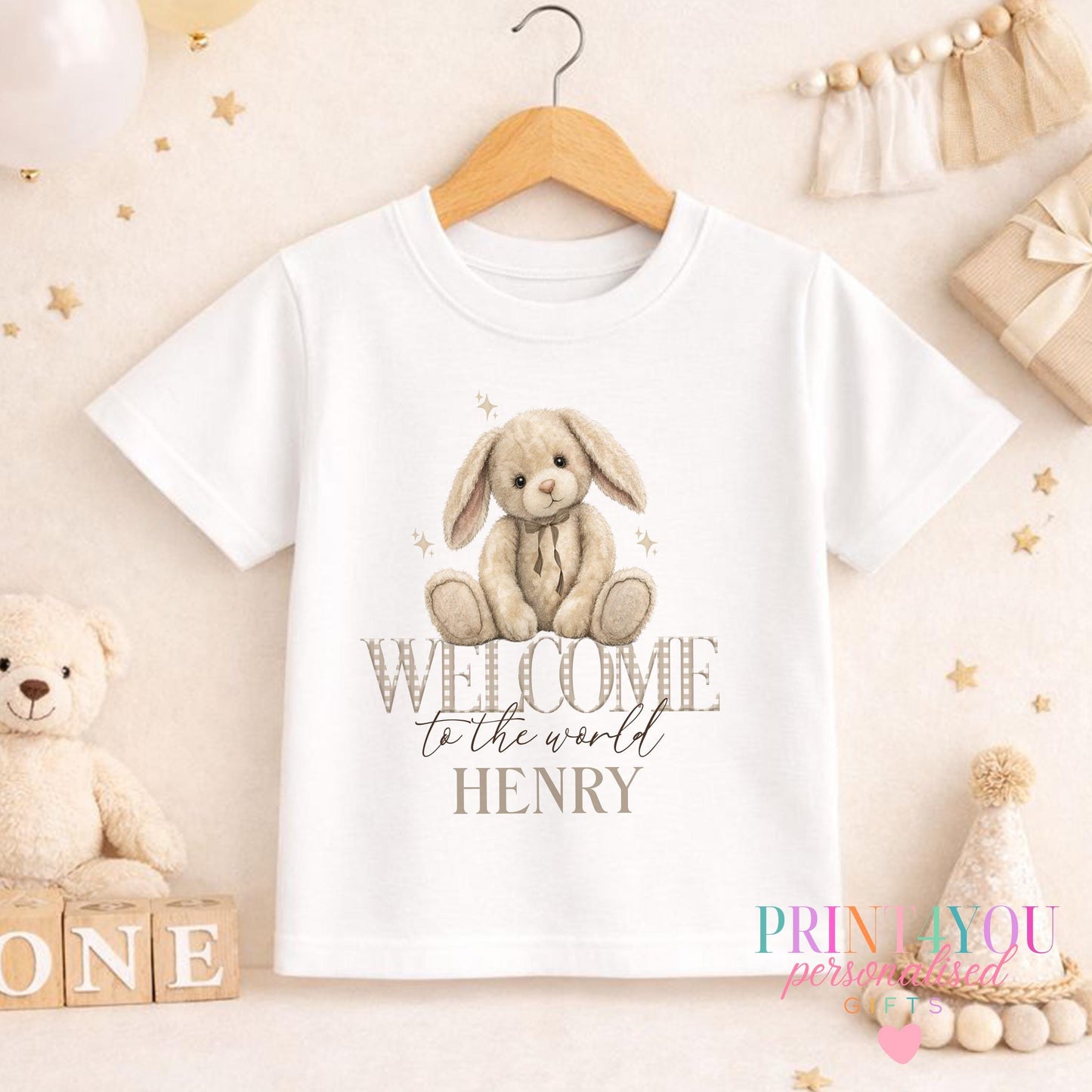 Personalised welcome to the world bunny baby bib with custom name, laid flat to show the print.