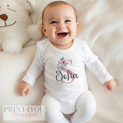 Personalised pink floral vest for a new baby girl, printed with a custom name.