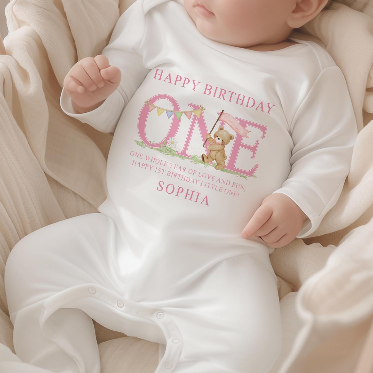 Pink striped baby garment styled for a first birthday cake smash photo.