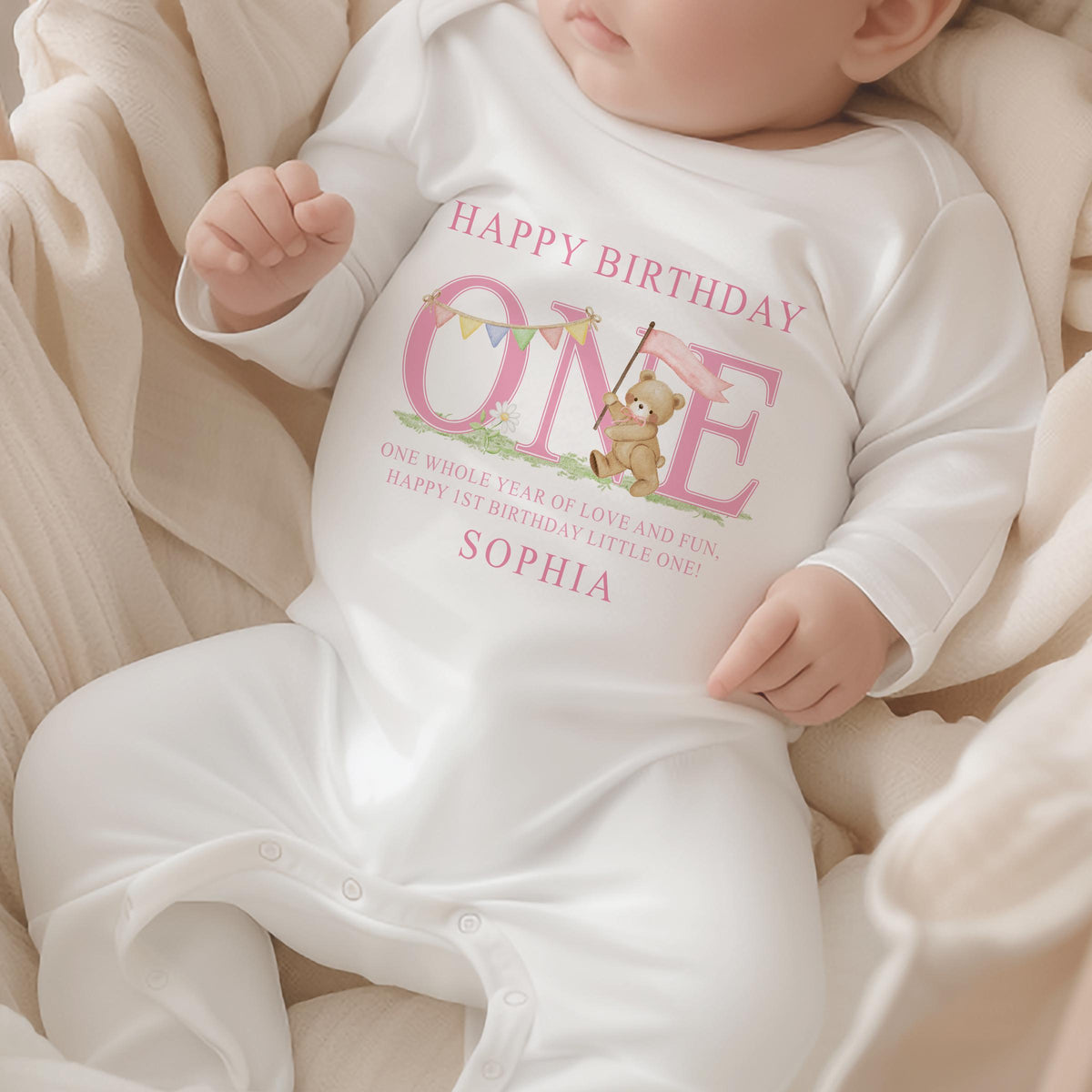 Pink striped baby garment styled for a first birthday cake smash photo.