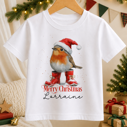 A white t-shirt with a Christmas-themed graphic of a bird wearing a Santa hat and red boots, along with the text "Merry Christmas Lorraine".