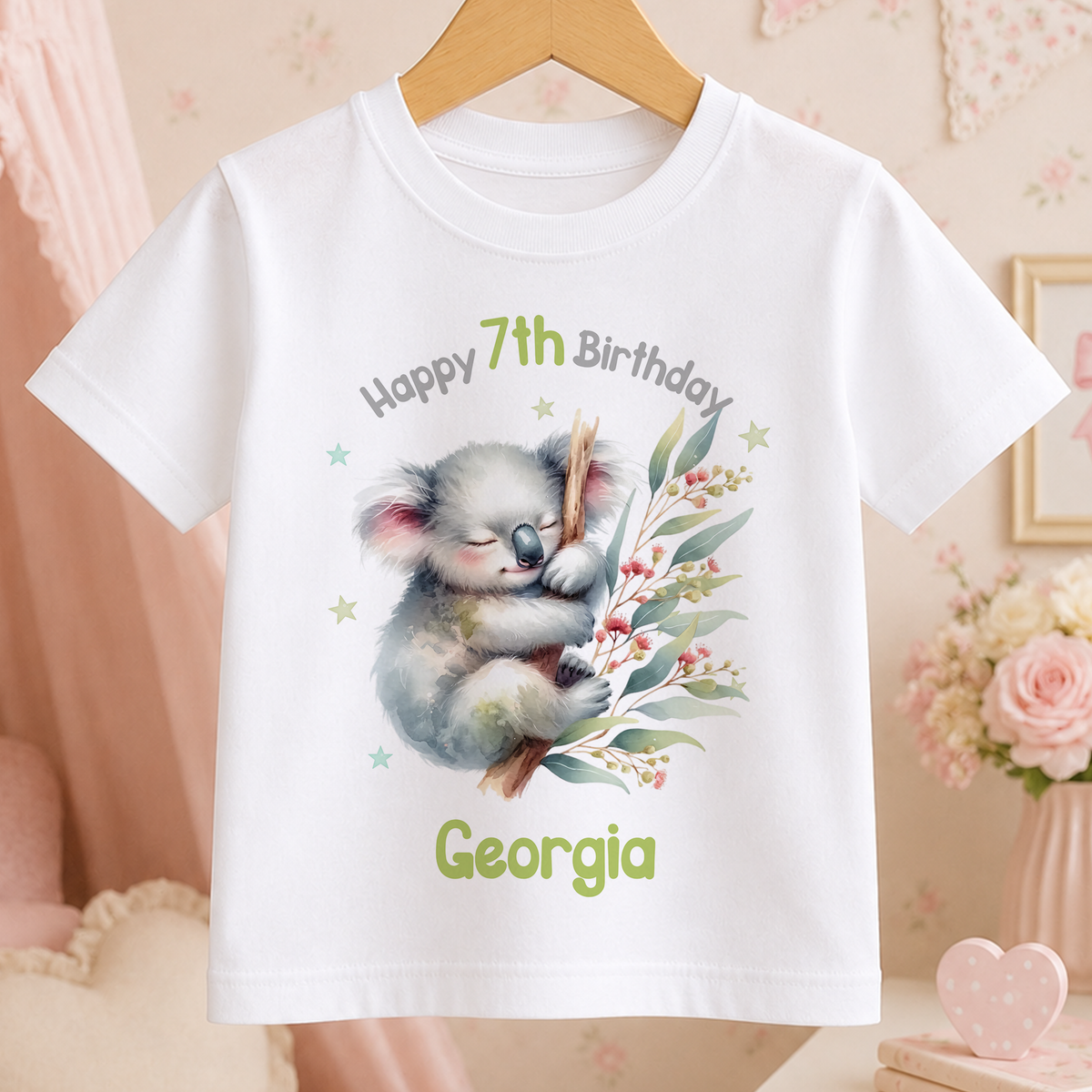 White cotton t-shirt with a personalised koala graphic reading Happy 7th Birthday Georgia
