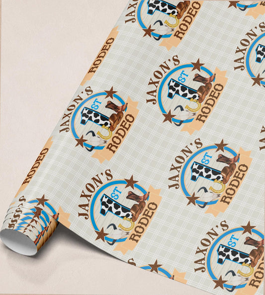 The image is a roll of wrapping paper with a repeating pattern of a cow and a horse, along with the text "JAXON'S RODEO" printed on it.