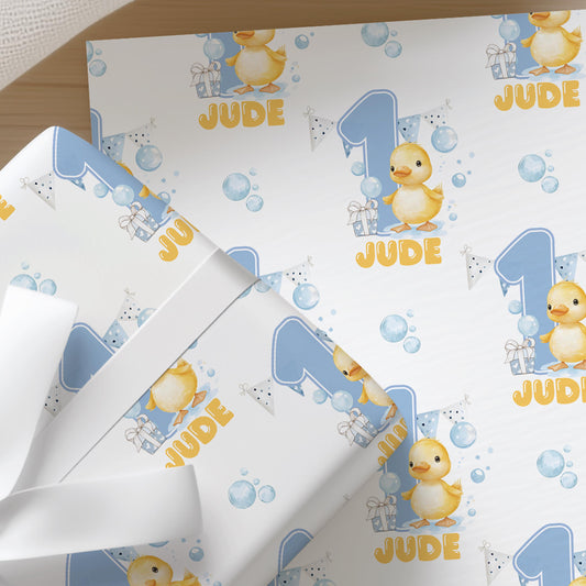a pattern of blue and white duck illustrations, with the word "Jude" written in the center. The pattern repeats across the image, creating a cohesive design.