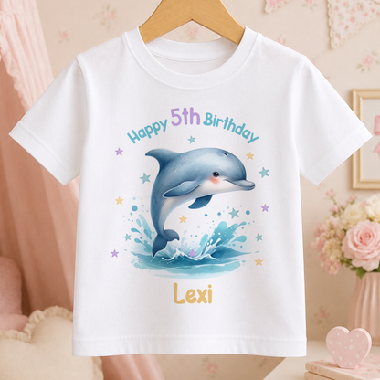 White children's t-shirt personalised with a jumping dolphin, stars and a custom birthday name and age