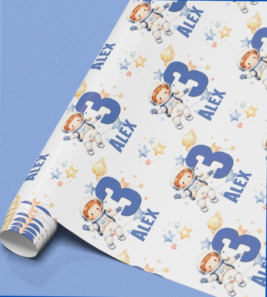 Roll of astronaut wrapping paper featuring a boy in a spacesuit, personalised with the name Alex.