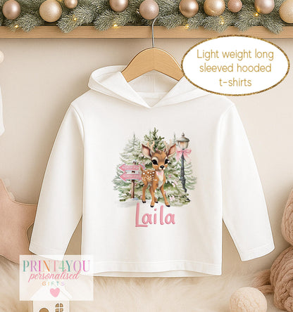 Personalised Christmas hooded t-shirt for girls, white lightweight long sleeved hoodie printed with a fawn among pink winter blooms and a name