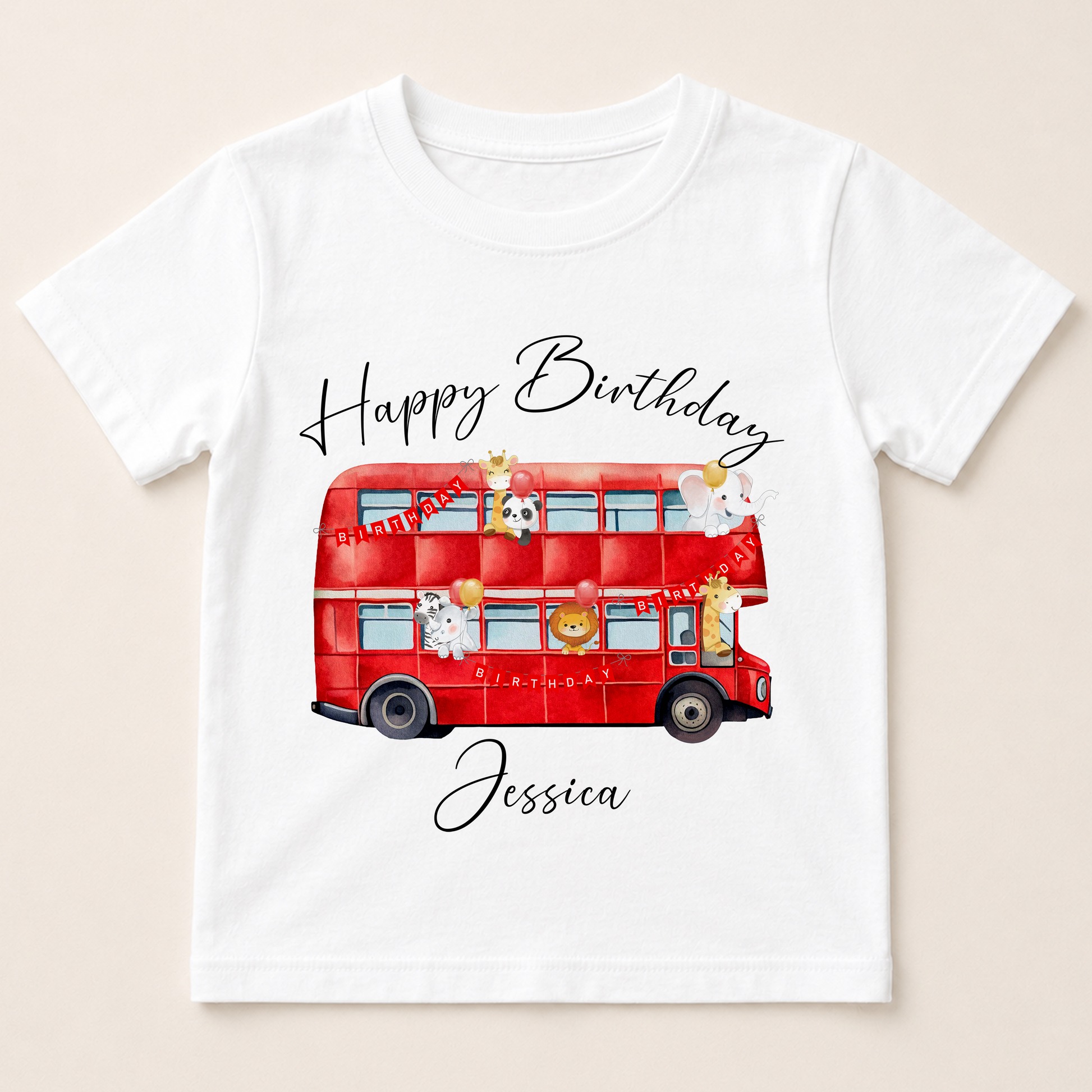 A white t-shirt with a red double-decker bus and various cartoon animal characters printed on it.