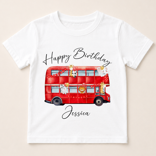 A white t-shirt with a red double-decker bus and various cartoon animal characters printed on it.