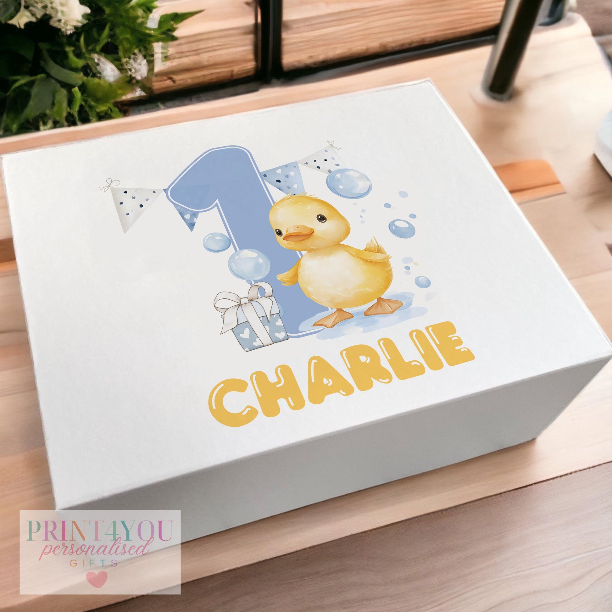 White magnetic-close keepsake box for a baby's first birthday, personalised with the child's name and printed with a blue bubbles duck design, shown in the medium 160 x 200 x 80mm size