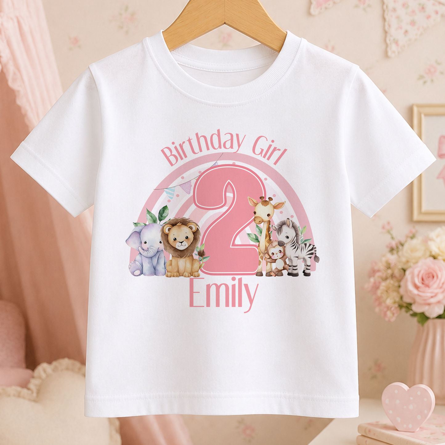 A white t-shirt with a pink and green animal print design, featuring a large pink number 2 and the text "Birthday Girl Emily" on it.