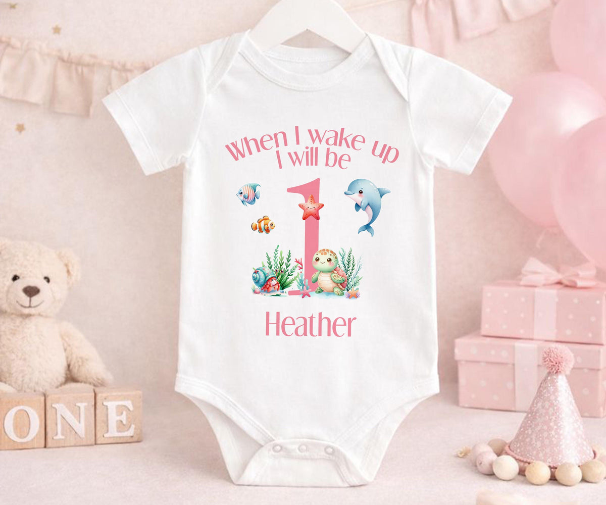 Close-up of the under-the-sea print on personalised pink striped 1st birthday pyjamas