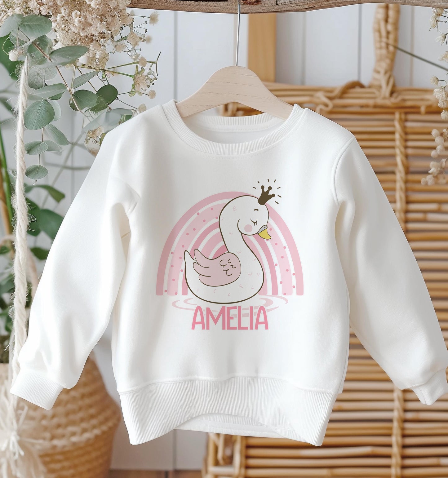 Personalised white cotton sweatshirt with pink rainbow swan design and custom name, baby size 6-12 months