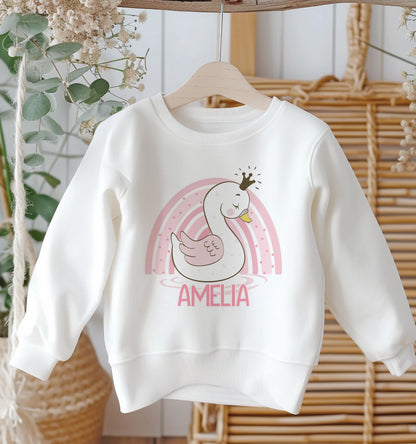 Personalised white cotton sweatshirt with pink rainbow swan design and custom name, baby size 6-12 months