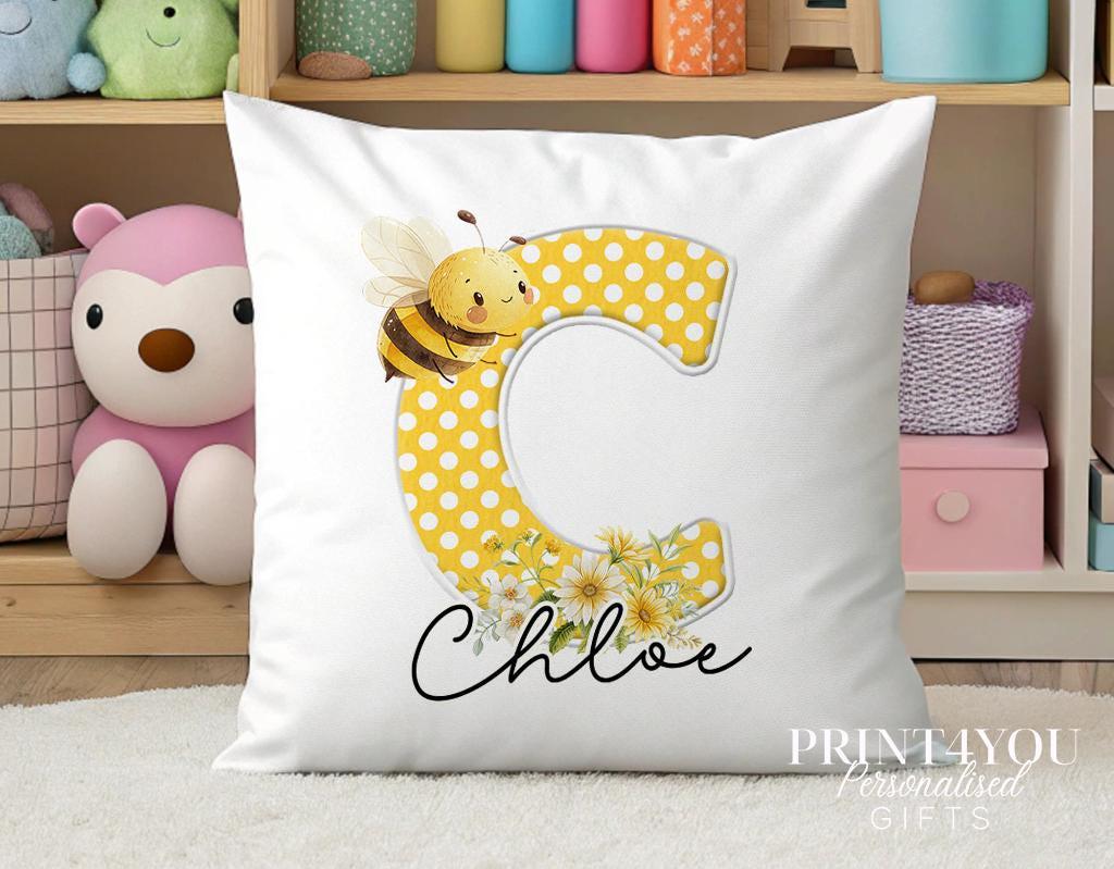 Close-up of the bee cushion showing the personalised name and cotton cover