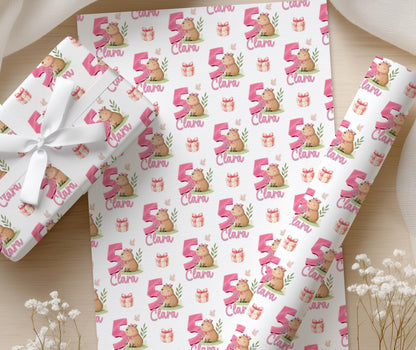 Personalised capybara wrapping paper wrapped around a gift box with the custom name and age visible.