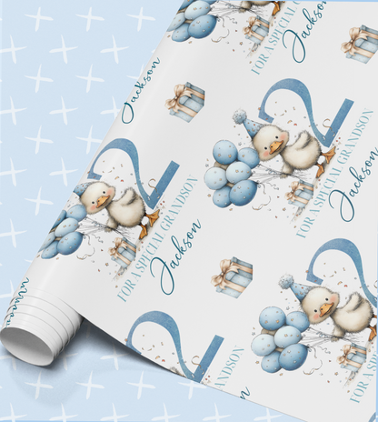a pattern of blue balloons, a cute duck, and gift boxes, all set against a light blue background with white crosses.