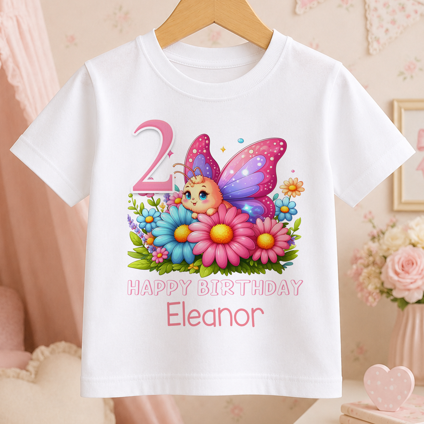 A white t-shirt with a colorful butterfly graphic and the text "Happy Birthday Eleanor" printed on it.