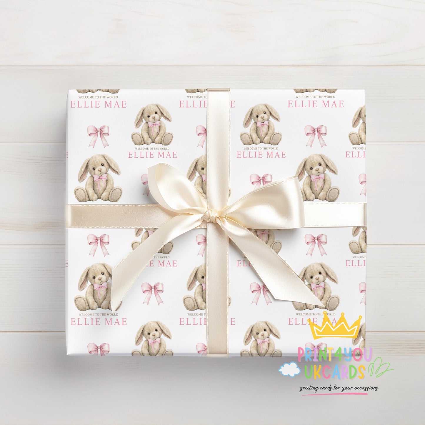 Personalised newborn wrapping paper sheet laid flat showing the full pink bunny and teddy repeat pattern