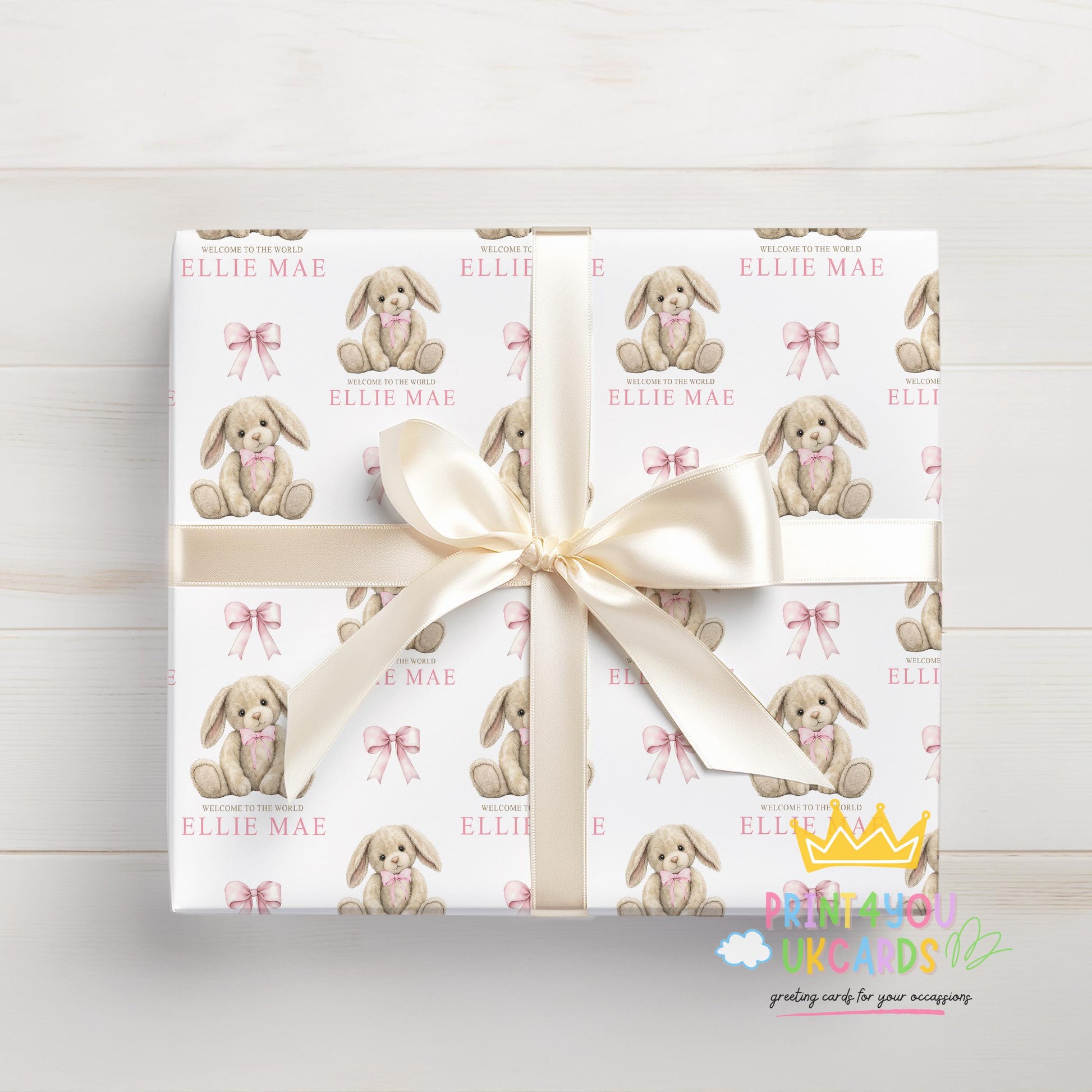 Personalised newborn wrapping paper sheet laid flat showing the full pink bunny and teddy repeat pattern