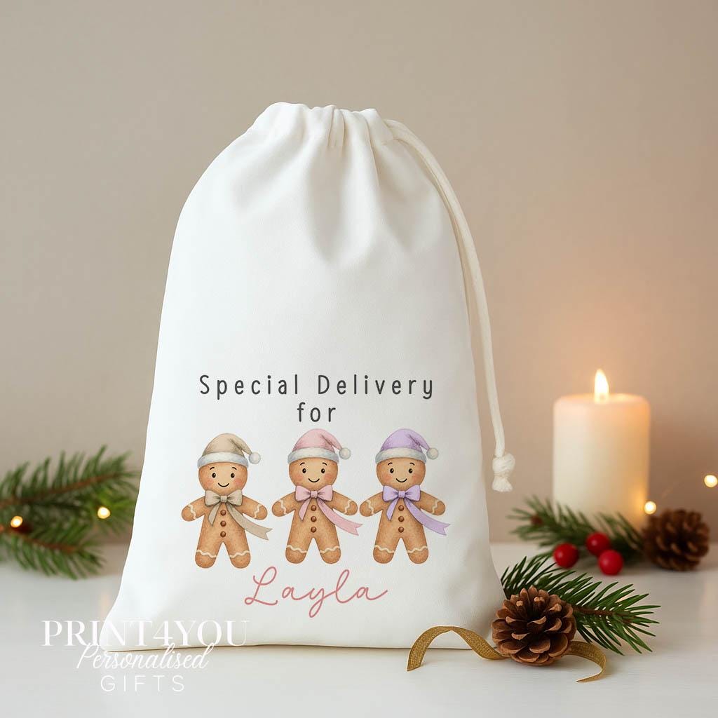 Personalised gingerbread Christmas sack, white A3 drawstring gift bag printed with three gingerbread men in pastel hats and Special Delivery for a name