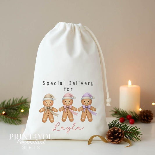 Personalised gingerbread Christmas sack, white A3 drawstring gift bag printed with three gingerbread men in pastel hats and Special Delivery for a name