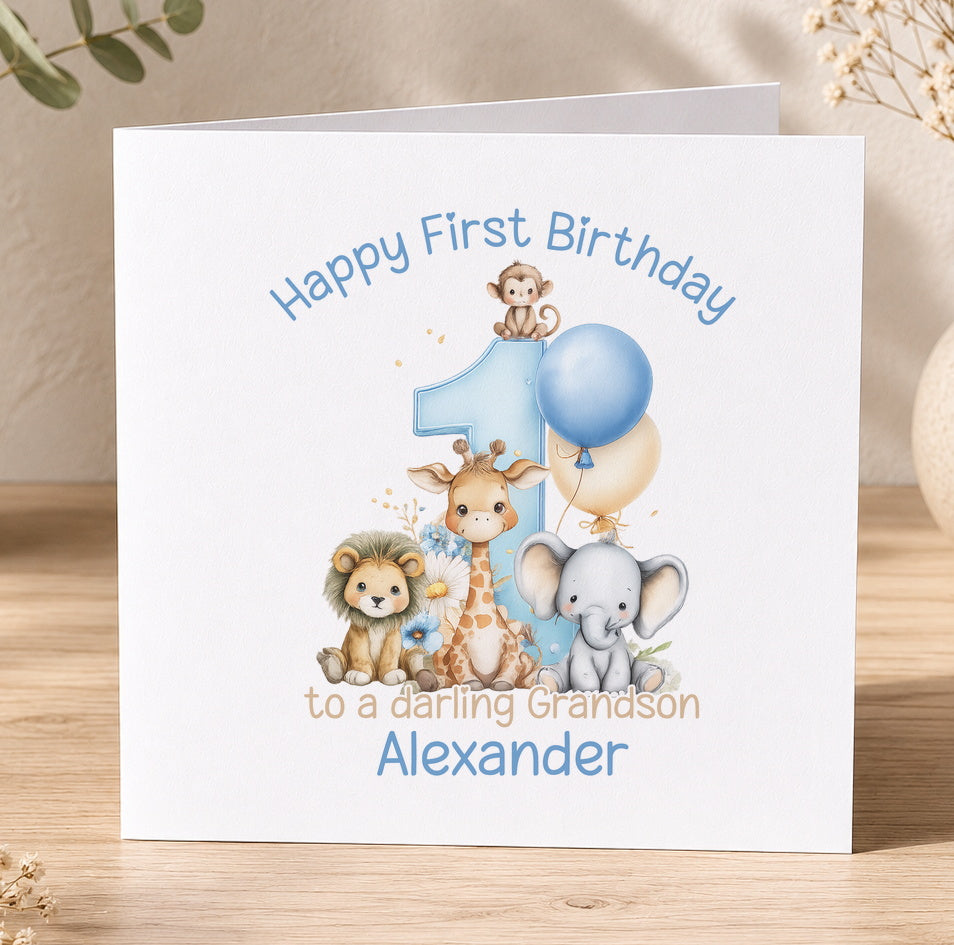 Blue safari-themed 1st birthday card for a grandson featuring a lion, giraffe, elephant and monkey with a blue balloon and the message 'Happy First Birthday to a Daring Grandson Alexander'.