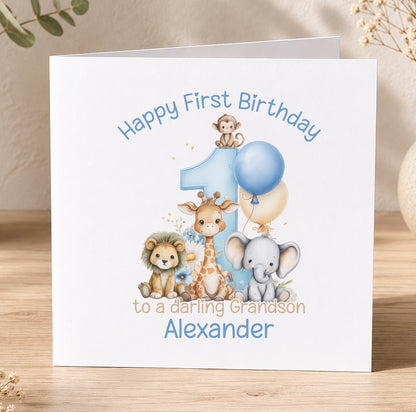 Blue safari-themed 1st birthday card for a grandson featuring a lion, giraffe, elephant and monkey with a blue balloon and the message 'Happy First Birthday to a Daring Grandson Alexander'.