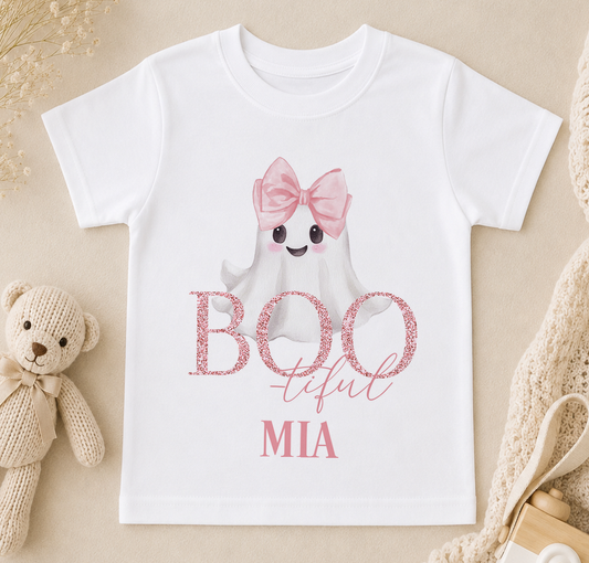 A white t-shirt with a ghost character wearing a pink bow and the text "BOO TIFUL MIIA" printed on it.