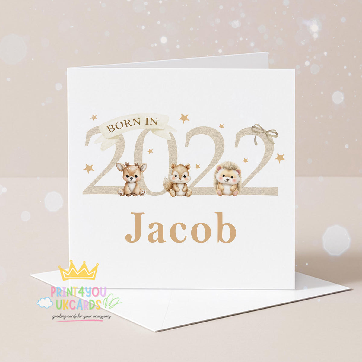 Square newborn baby card shown at an angle to display the beige woodland animal design and card stock.
