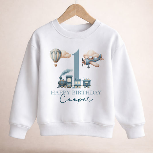 Personalised vintage transport first birthday jumper with hot air balloon, plane and train design and custom name.