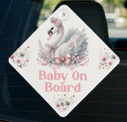 Diamond-shaped baby on board car sign featuring a swan illustration with a pink bow and flowers