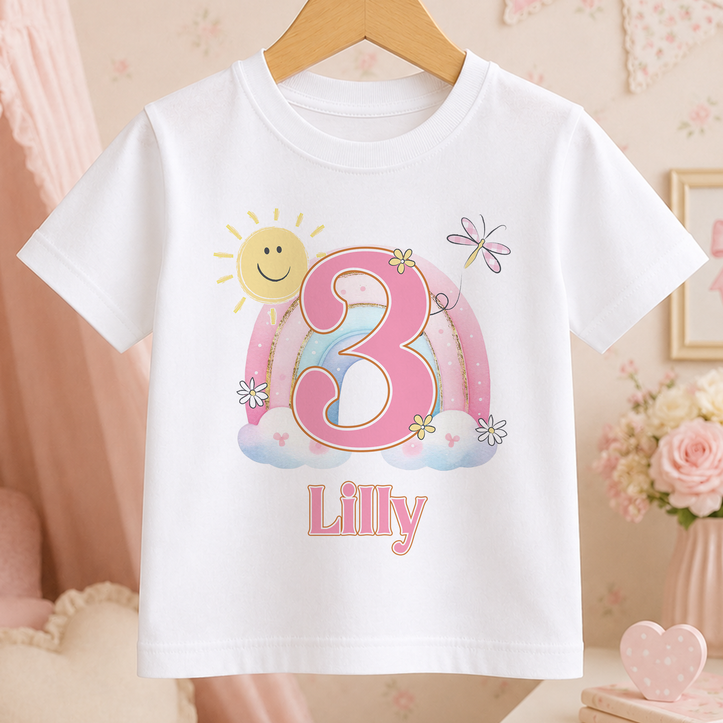 A white t-shirt with a personalized design featuring a sun, flowers, and the number 3, along with the name "Lilly" printed below.