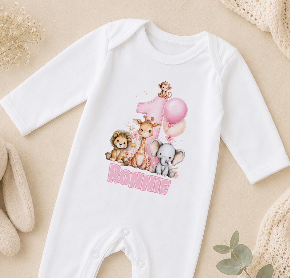 White baby onesie printed with safari animal illustrations, a pink balloon and the sample name 'Ronnie'