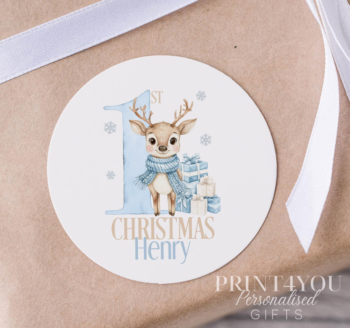 Personalised blue reindeer Christmas sticker on a strip, glossy white 5cm round gift label printed with a custom name