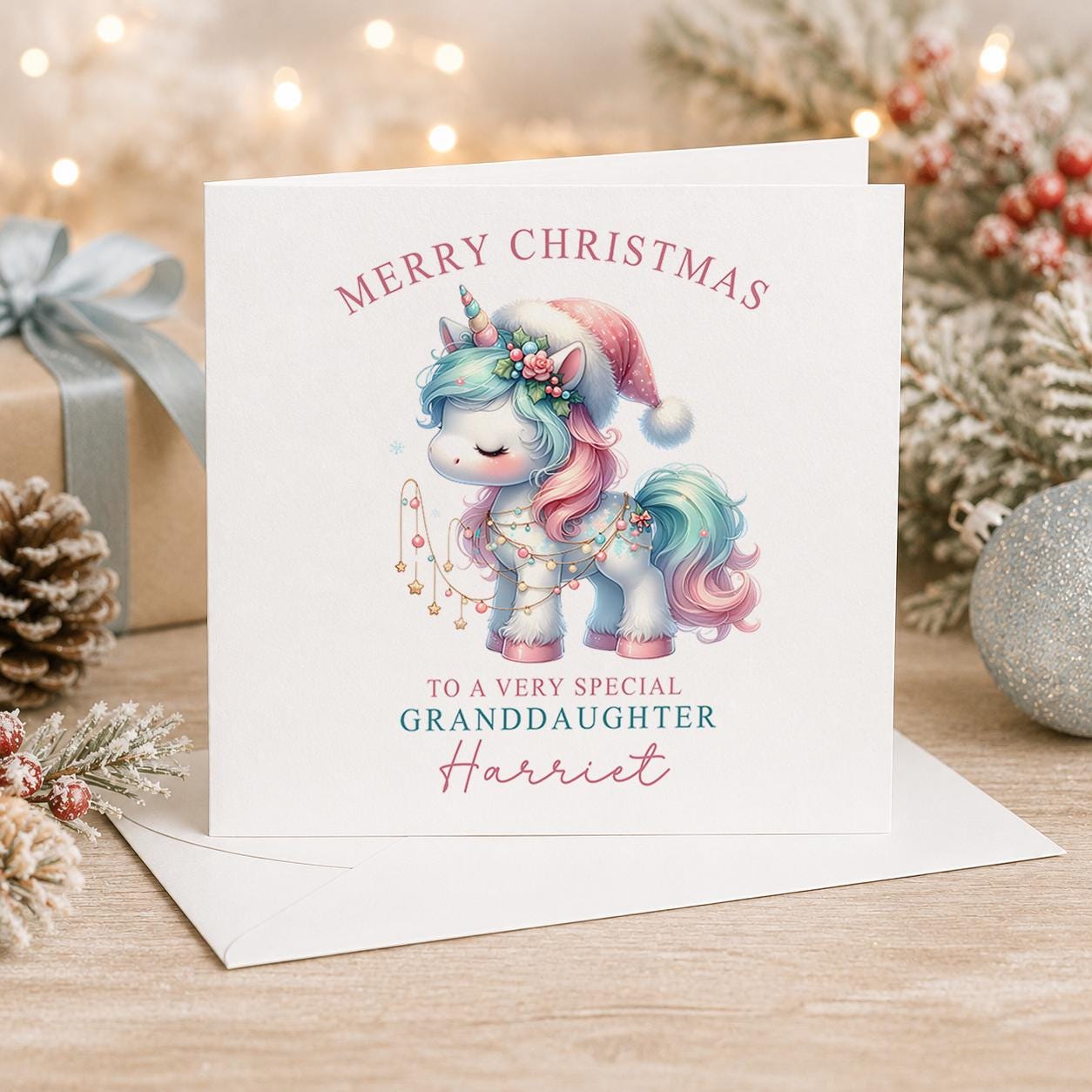 Personalised unicorn Christmas card, white 6x6 inch square card printed with a pastel unicorn in a Santa hat, Merry Christmas and a name