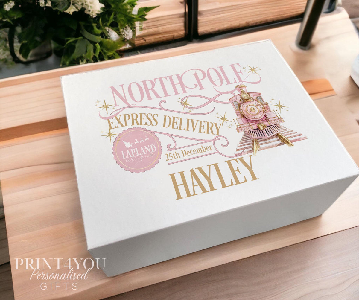 White Christmas keepsake box in the medium 16x20x8cm size, printed with a blush pink and gold North Pole Express train design, Lapland stamp and the name Hayley