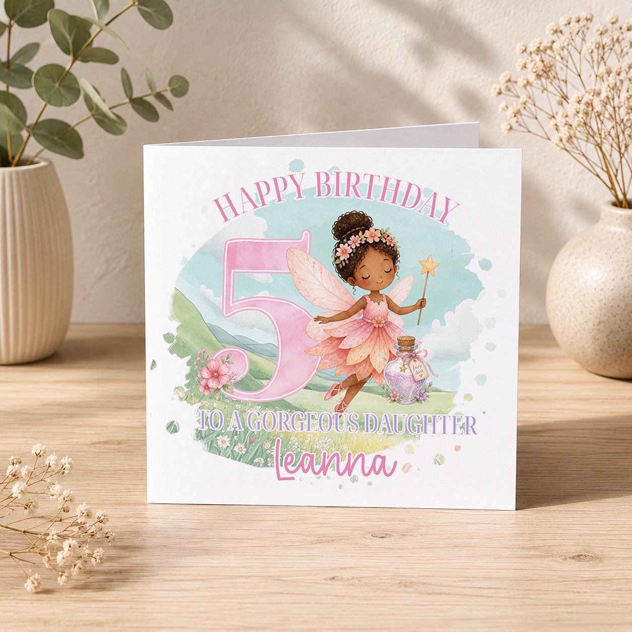 Square personalised fairy birthday card featuring a fairy with brown skin, wings and a flower crown, designed for a daughter's birthday.