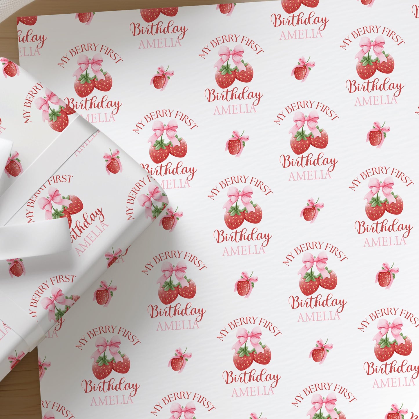 Personalised strawberry wrapping paper printed with a custom name, shown as a full sheet