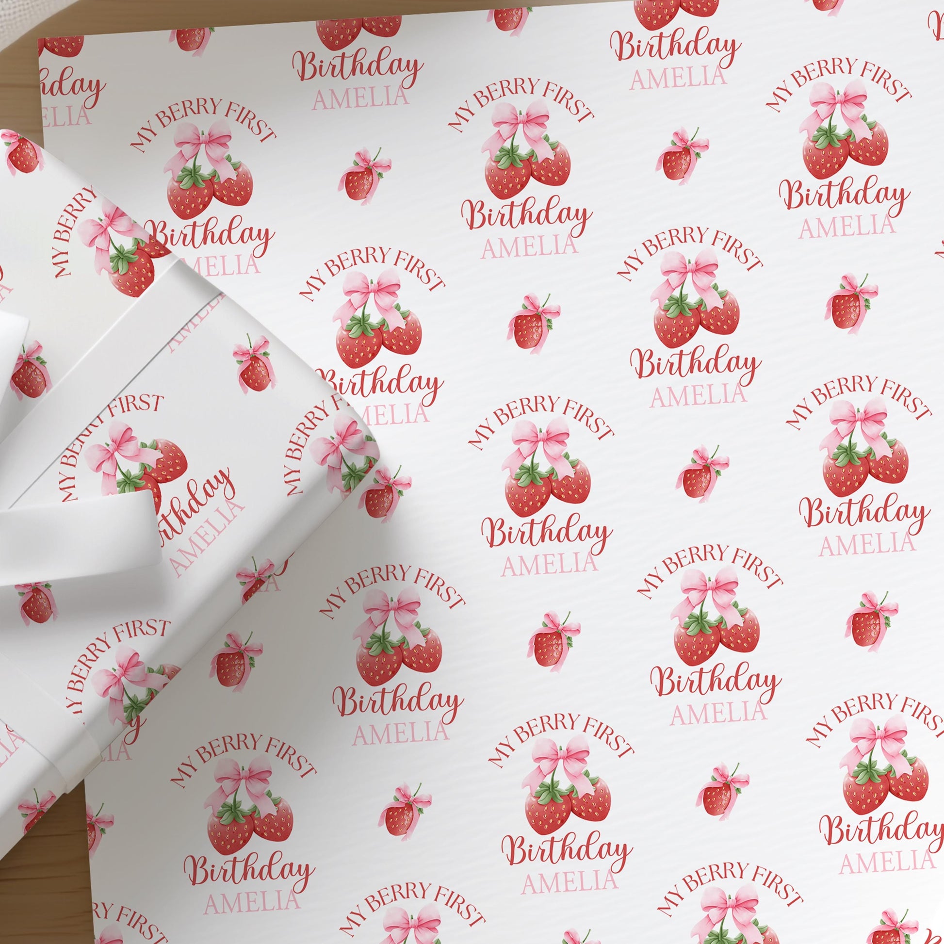 Personalised strawberry wrapping paper printed with a custom name, shown as a full sheet