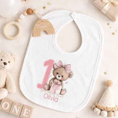 Pink teddy bear themed personalised first birthday outfit, styled with keepsake props for photos.