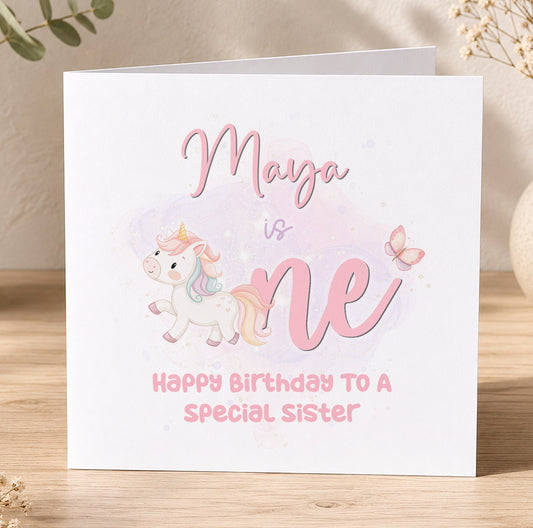 Personalised pink unicorn 1st birthday card printed with a child's name, featuring a unicorn and butterflies design