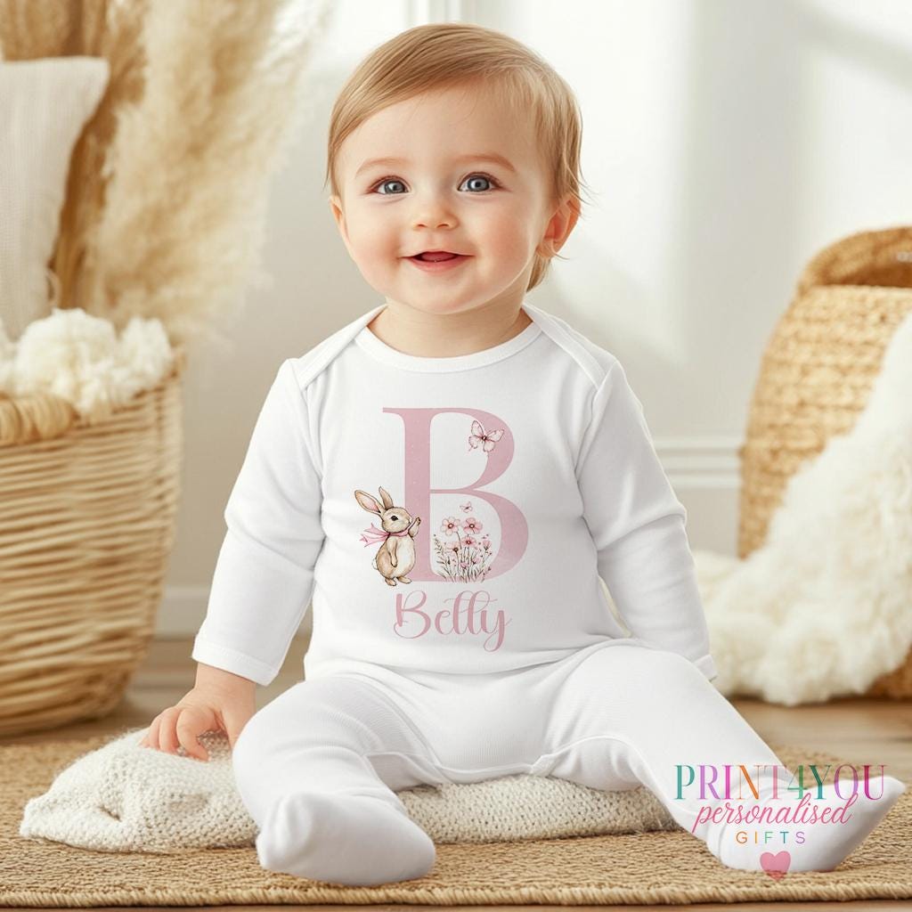 Personalised bunny sleepsuit with a floral design, custom printed with the baby's name.