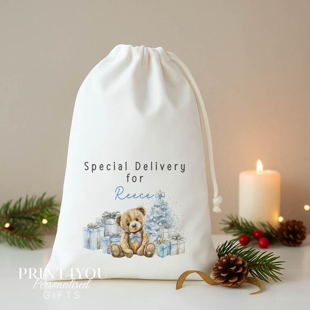 Personalised blue teddy Christmas sack, white A3 drawstring gift bag printed with a teddy bear and blue presents and Special Delivery for a name
