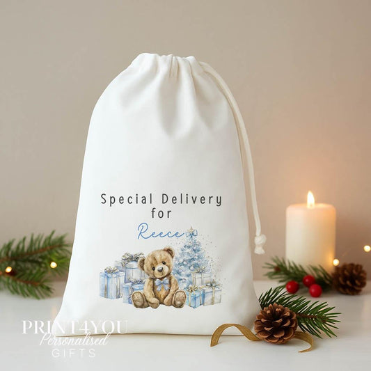 Personalised blue teddy Christmas sack, white A3 drawstring gift bag printed with a teddy bear and blue presents and Special Delivery for a name