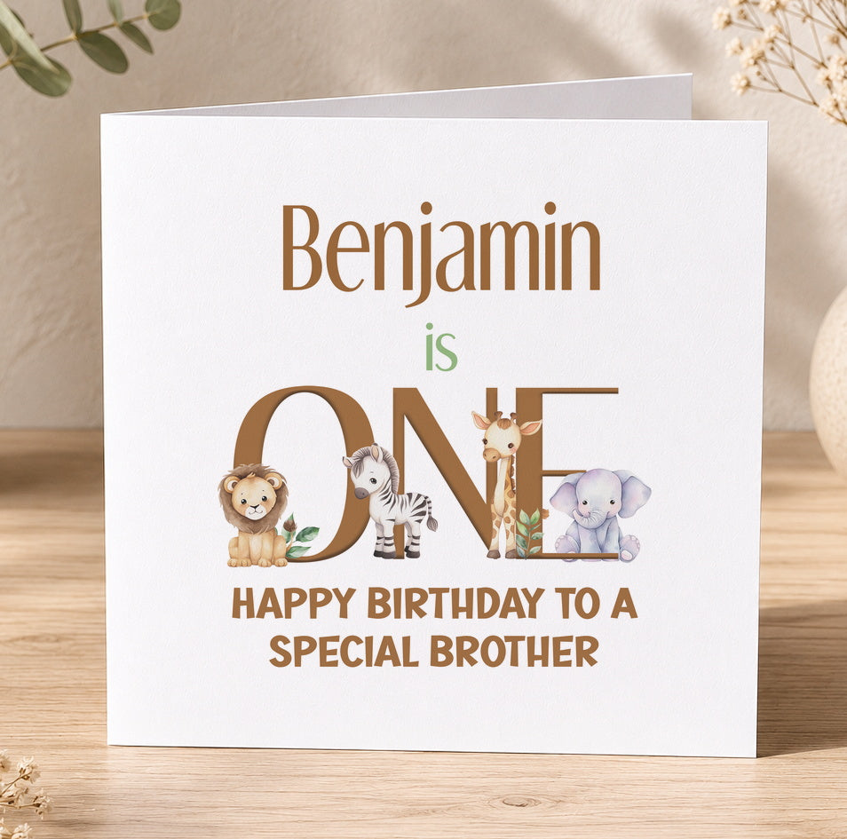 Square jungle-themed first birthday card for Benjamin, with the name spelled out using illustrated safari animals including a lion, zebra, giraffe and elephant, reading 'Happy Birthday to a special brother'.