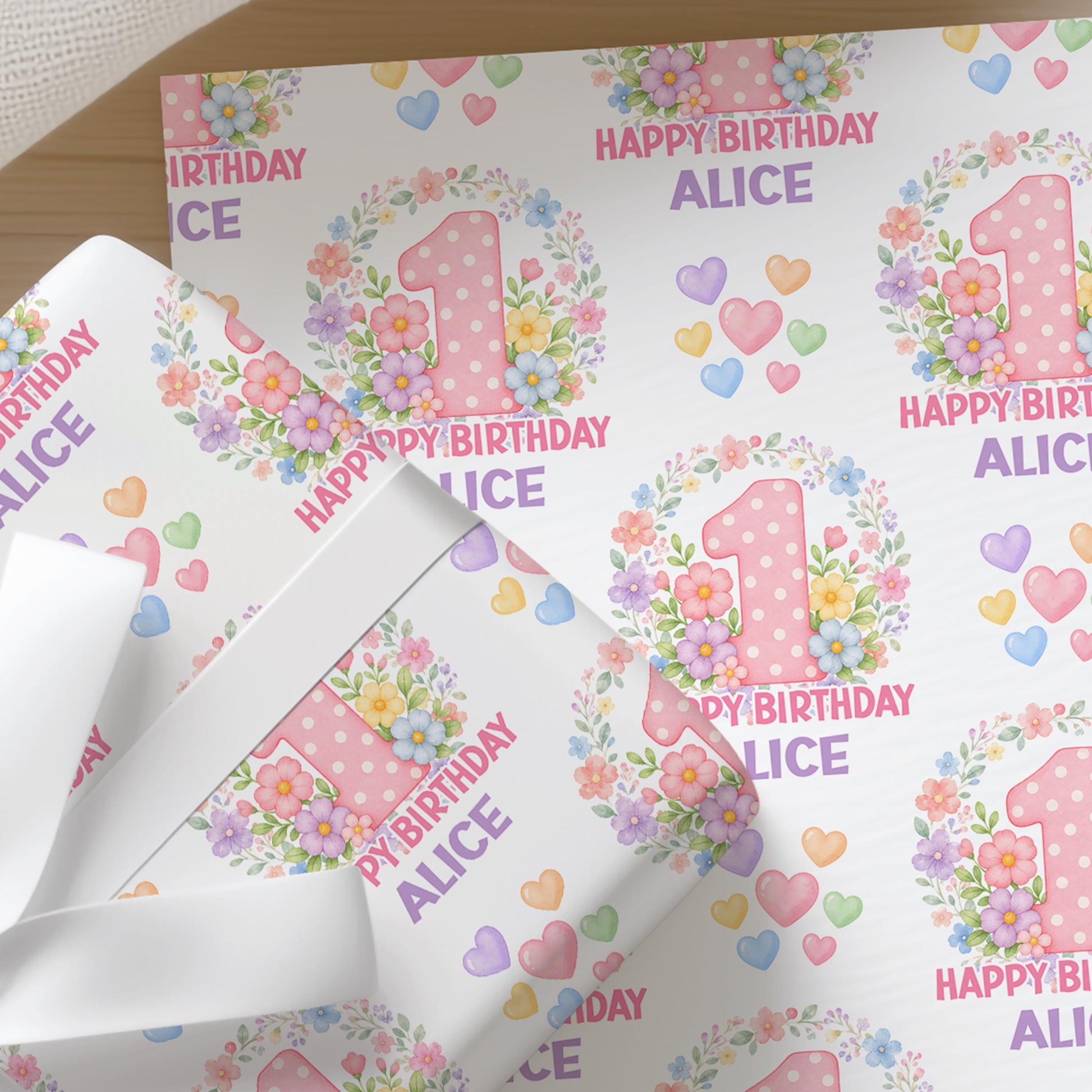 Personalised blossom number wrapping paper sheet laid flat showing the full repeating floral number pattern with name.