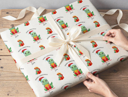 Personalised T-Rex Christmas wrapping paper wrapped around a gift