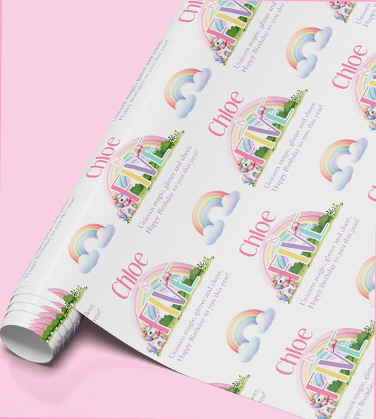 Roll of pink rainbow unicorn wrapping paper personalised with the name Chloe.