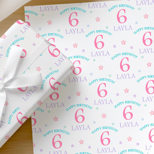 Personalised pastel birthday wrapping paper featuring custom name and age, colourful stars and birthday wording, gift wrap for girls aged 1-9.